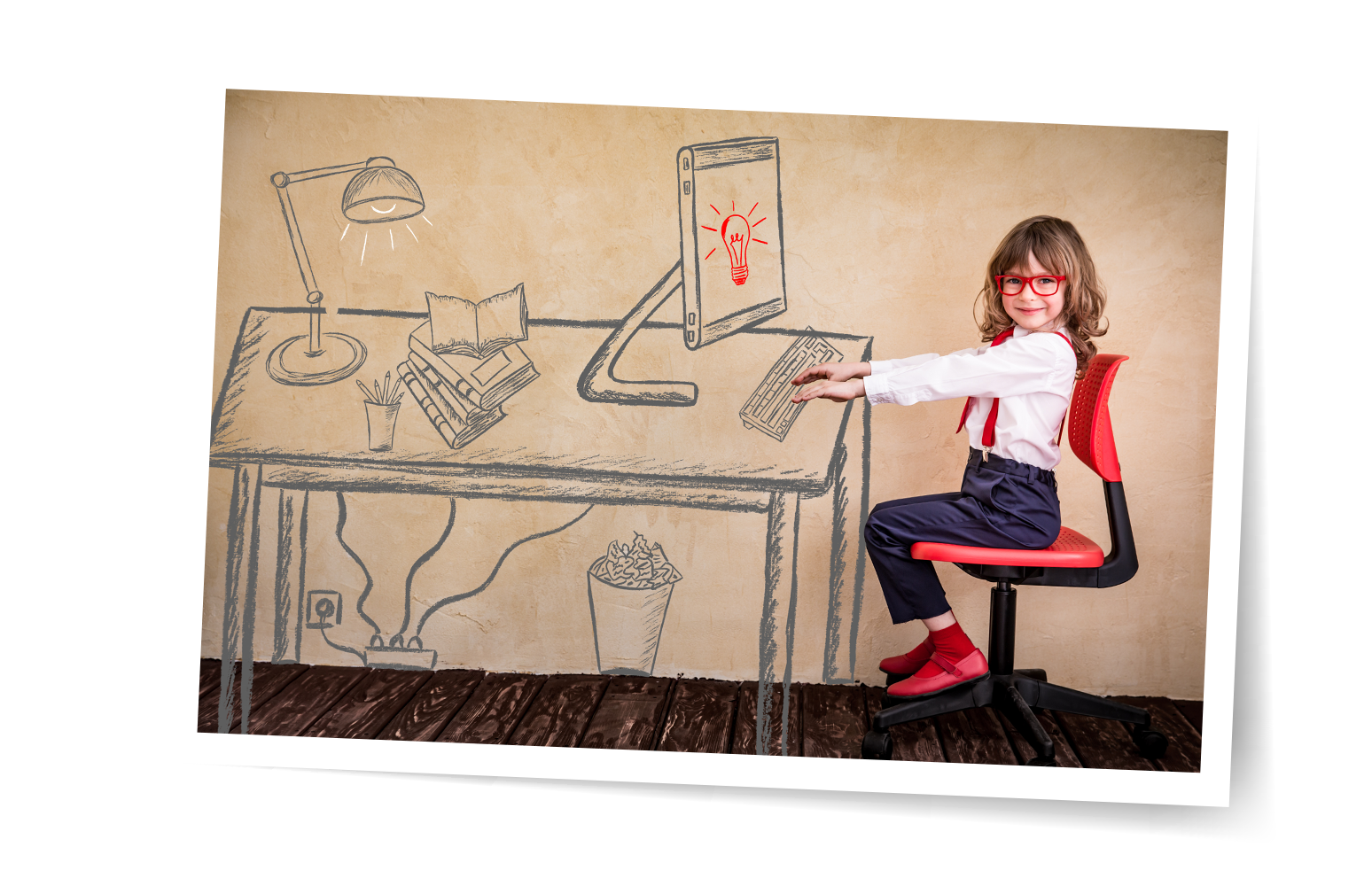 picture of a girl sitting at a drawing of a desk